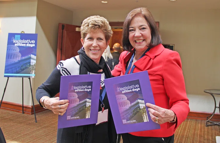 Penny Fraumeni and Sue Kaiser grab their folders for Legislative Action Days. 
