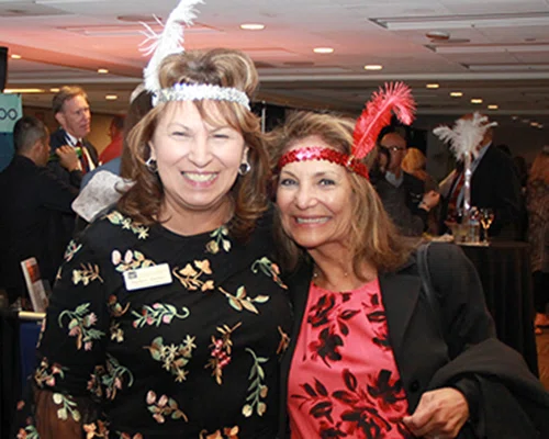 Martha Martinez and Ofelia Lariviere get into the spirit of the Roaring ‘20s themed reception.