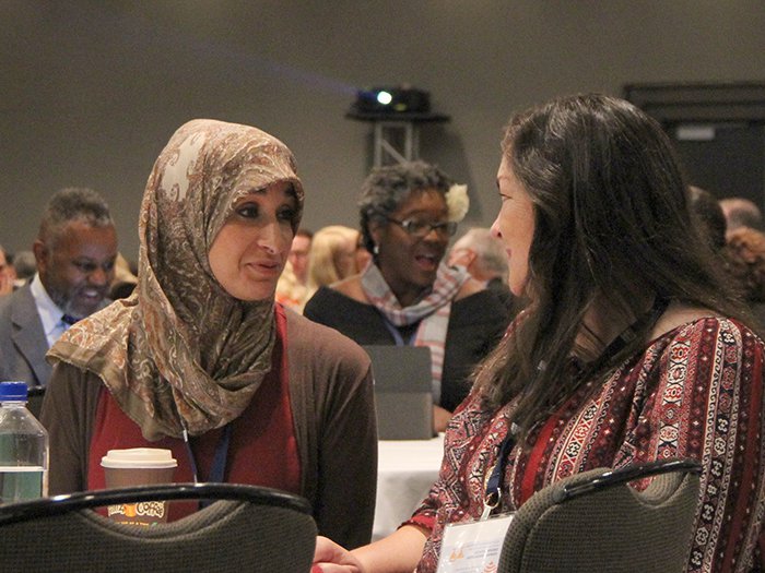 Attendees share during a keynote presentation.