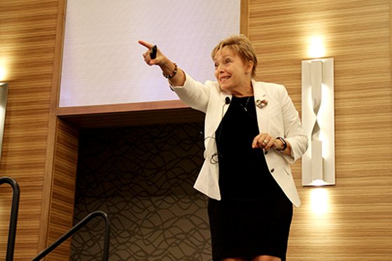 Lisette Estrella-Henderson points to attendees at 2019 WLF.