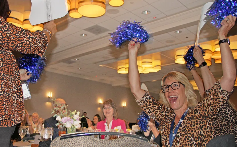 Ashley Grim cheers for Denise Wickham, center, ACSA's 2023 Exemplary Woman in Education.