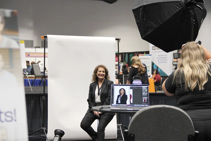 CALSA's Ofelia Ceja-Lariviere poses for a professional headshot in the Exhibit Hall.