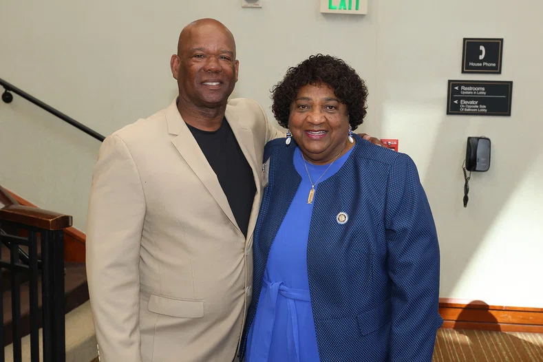 Tracy Thompson with his former teacher and California Secretary of State Shirley Weber.