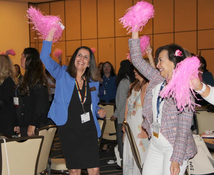 Attendees wave pom-poms at the “Visualize to Realize” session.