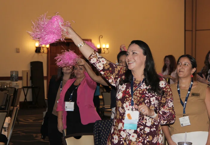 Attendees wave pom-poms at the “Visualize to Realize” session.