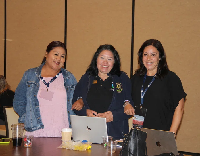 Attendees link arms with their “sisters” during Shelley Jones-Holt’s presentation.