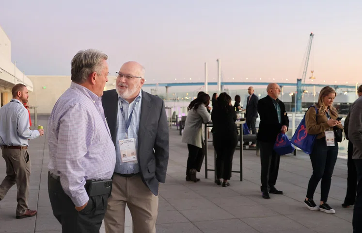 Scott Nanik and Ron Carruth chat at the welcome reception, overlooking the Coronado Bridge.