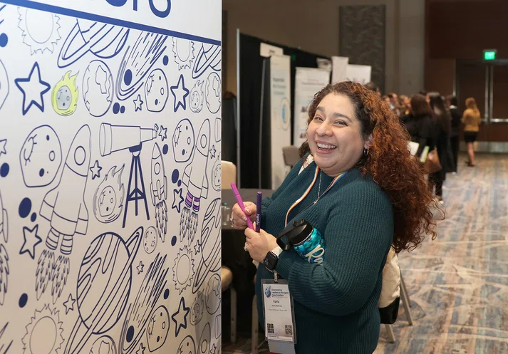 Attendee Karla Rahiman fills in the coloring wall.