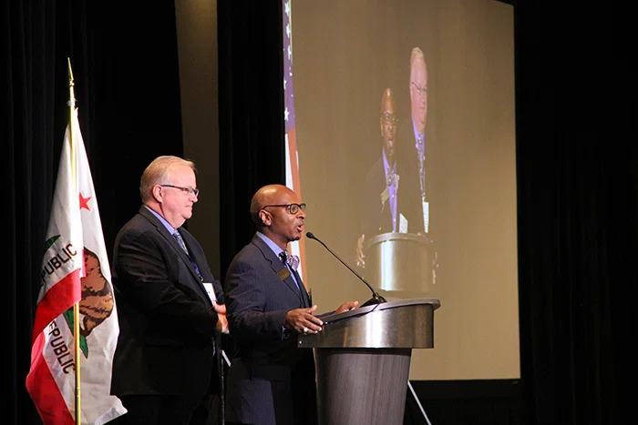 Summit Planning Committee Co-chairs Daryl Camp and Jon LeDoux greet attendees.