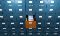 File drawer pulled out in wall filing cabinet.