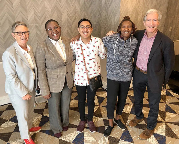 Ellen Khan with Human Rights Campaign poses with student panelists and Jonathan Raymond.