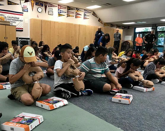 Fifth grade students demonstrate CPR.