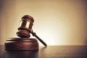 A wooden gavel sitting on a table.