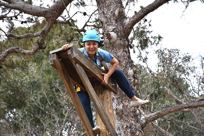 Horace Cureton Elementary School Principal Le Tran makes it up the shaky telephone pole.