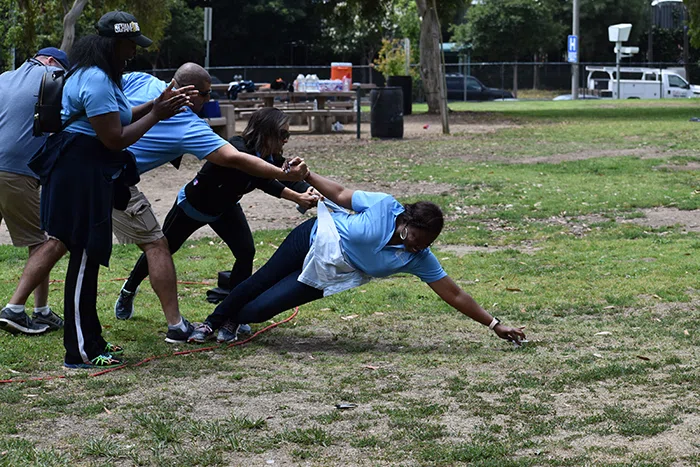 Principals work together to reach an object placed outside of a circle.