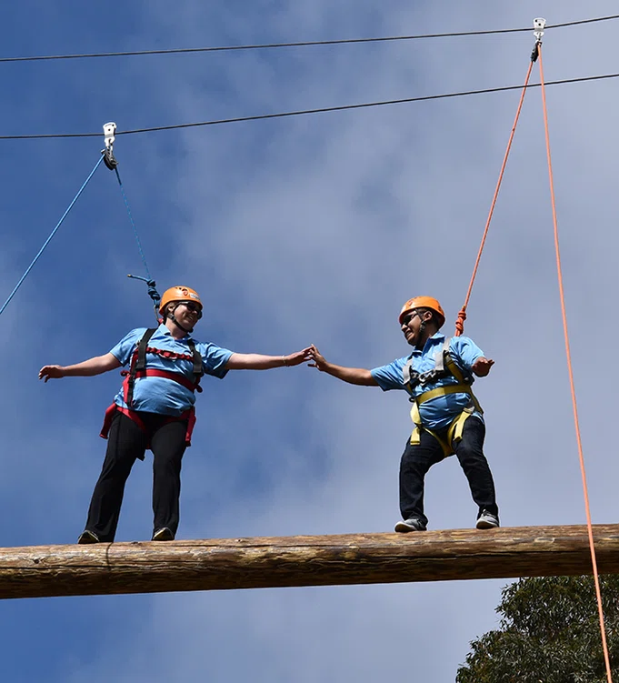 Principals on the ropes course.