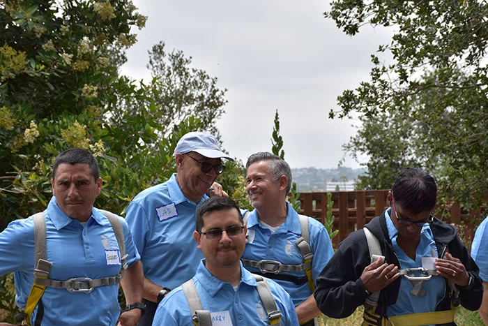 Principals prepare for the ropes course.