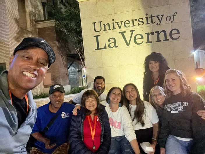 Team leaders at the University of La Verne sign.