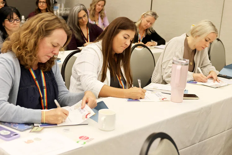 Attendees write a letter to their future selves during Michelle Elliott’s session.