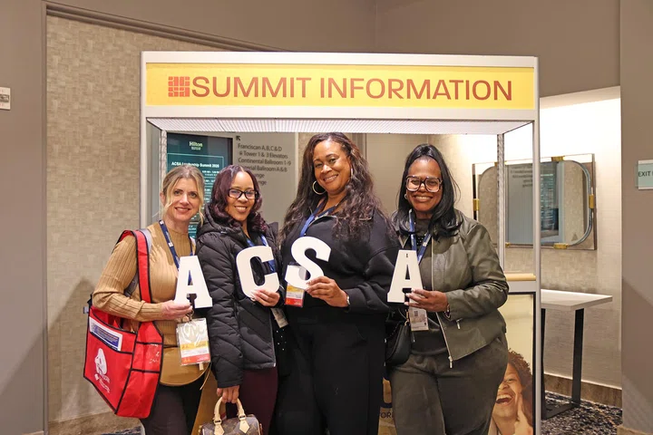 Attendees pose for a photo.