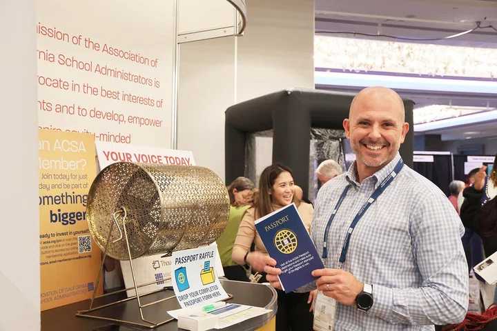 Michael Breyer puts his passport into the raffle.