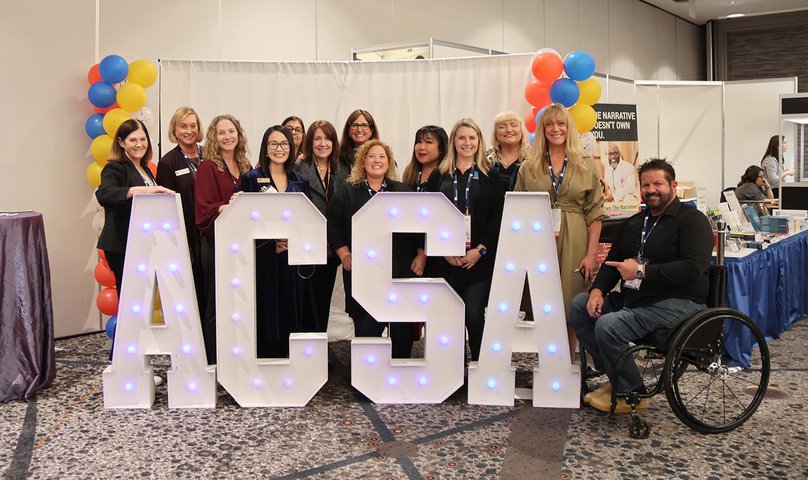 Attendees snap a photo with the ACSA letters.