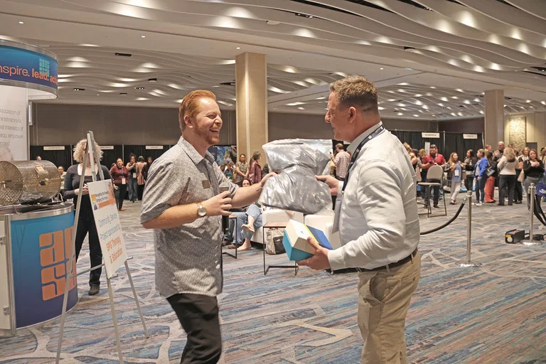 ACSA staff Kory Adams announces winners at the closing raffle.