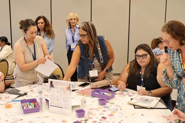 Participants use stickers and scrapbooking materials to bring their visions to life.