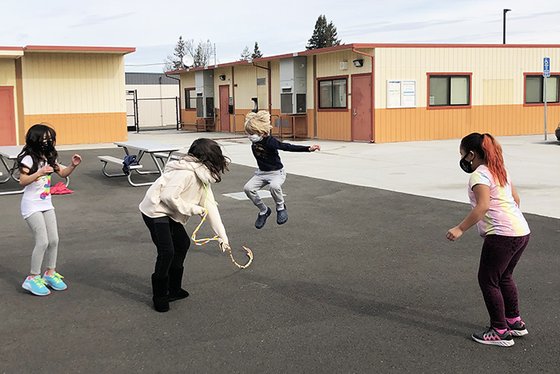 Students play jump rope in their learning pod.
