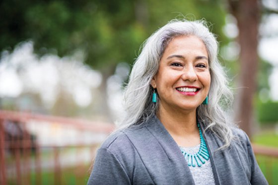 A smiling woman with gray hair.
