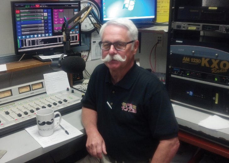 A radio broadcasting executive sitting in his booth.