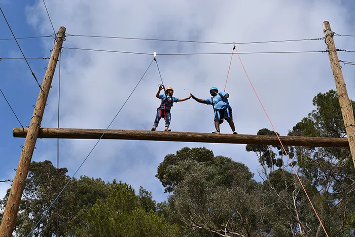 Principals on the ropes course.