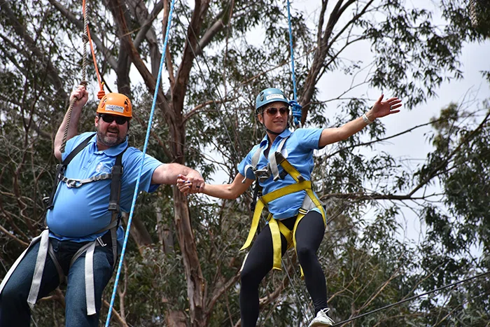 Principals on the ropes course.